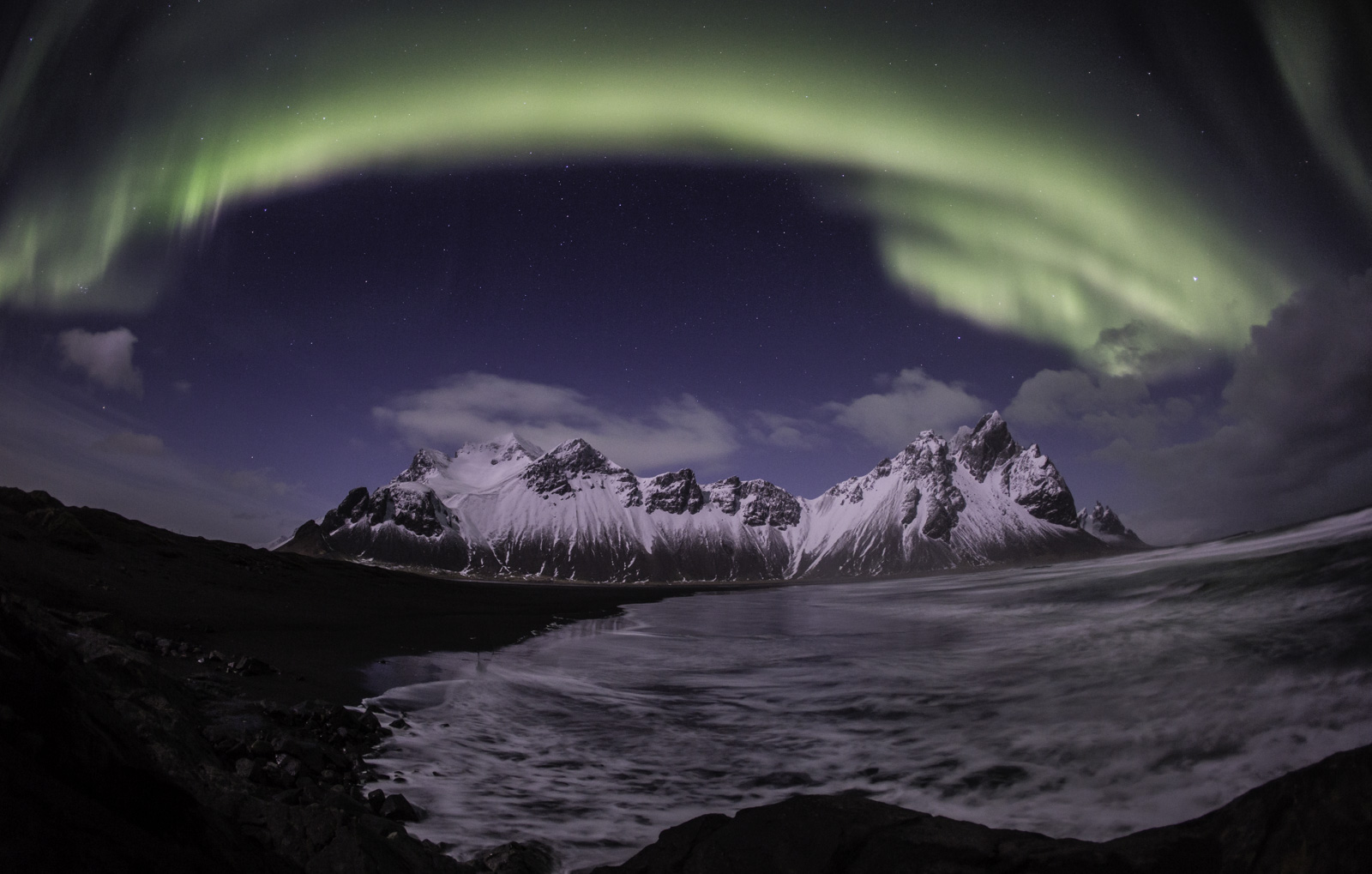 Northern Lights on Stokksnes Beach Stokksnes Black Sand Beach with green northern lights in the sky and Vestrahorn in the background